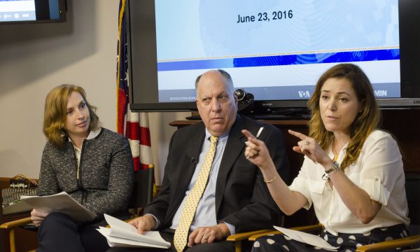 (L–R) Sonja Gloeckle, Ernie Torriero, and Natalia Crujerias sit in front of a screen speaking to a perceived audience