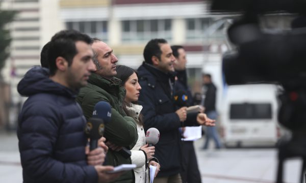 Five journalists lined up reporting