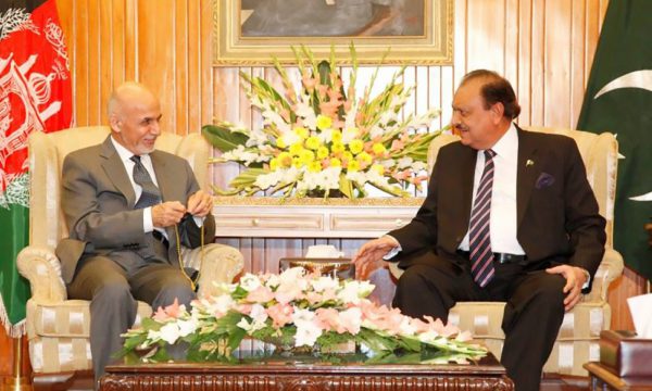 Presidents Mohammad Ashraf Ghani and Mamnoon Husain seated side-by-side with their respective country flags over their shoulders in a presidential office.