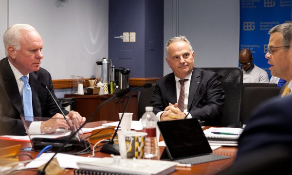 three men at table for board meeting