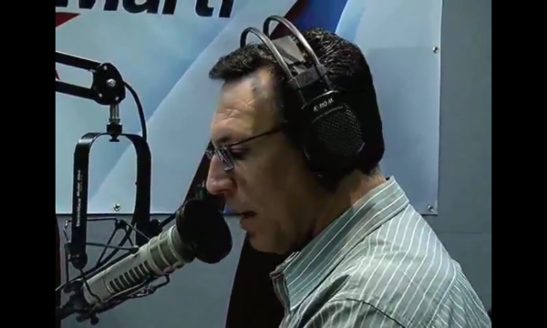 man in radio studio speaks into a microphone